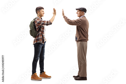 Male student greeting an elderly man with a high-five gesture