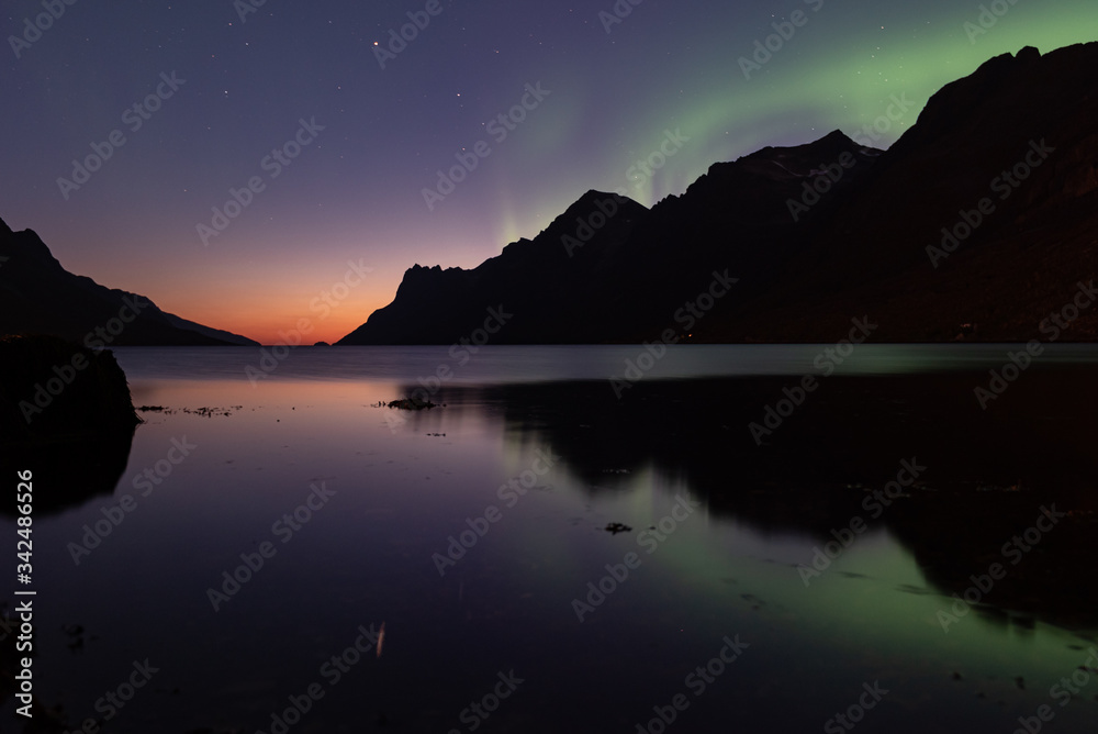 Arctic sunset with Northern lights on the background, Northern Norway 