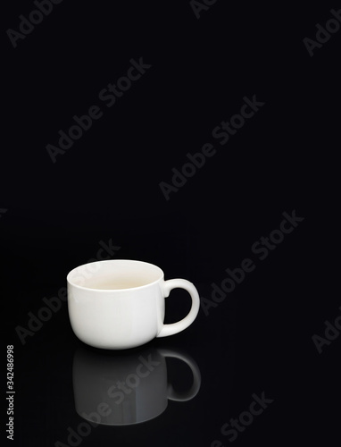 white coffee cup on black