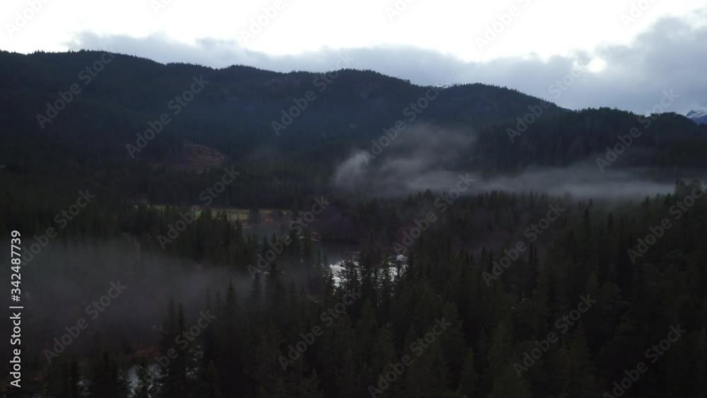 aerial drone of a foggy mountain range during the snow aerial drone of a foggy mountain range during the snow
