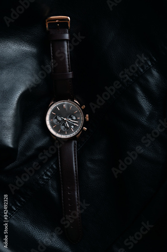 Gold LEATHER WATCH, VINTAGE STYLE WRIST WATCH, MEN'S LEATHER WATCH on leather background blur.