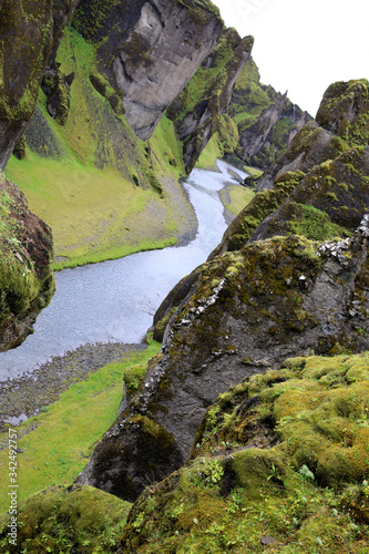 Sudhurland / Iceland - August 15, 2017: River flow through the great canyon of Fjadrargljufur. photo