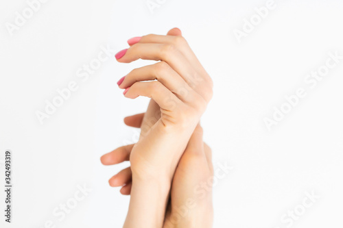 Elegant women s hands with a beautiful manicure on a white background. Close up