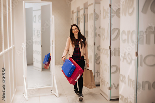 Portrait of young happy smiling woman with shopping bags