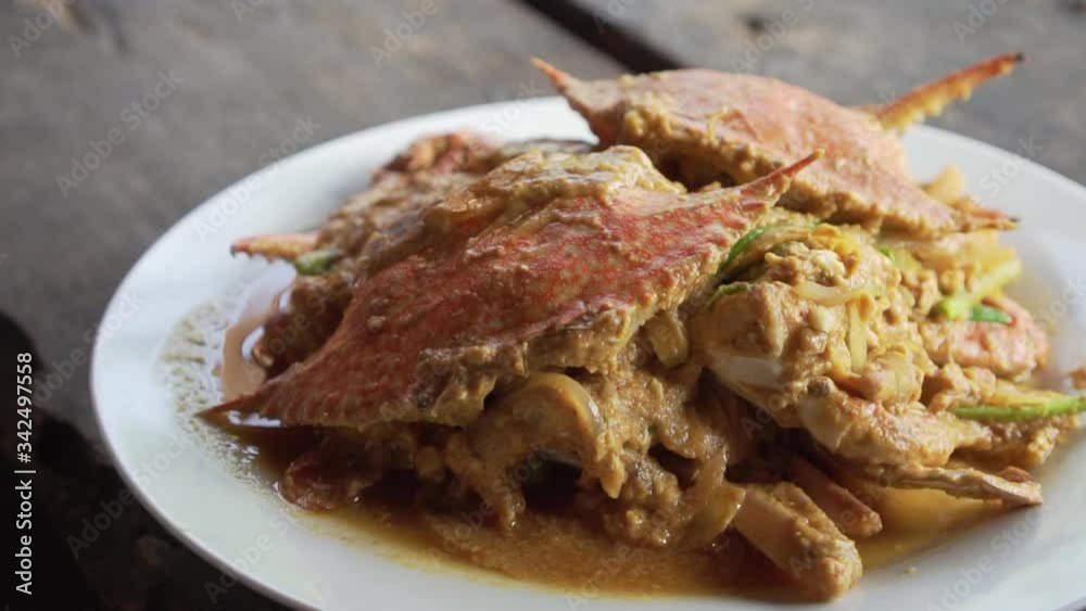 Full dish of Stir Fried Crab with Curry Powder. Seafood with delicious taste with wooden floor. thailand food with spicy taste.