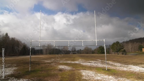 Football uprights with empty football field. Paint peeling. Off season. Ontario, Canada. photo