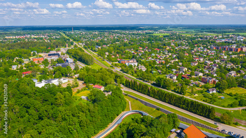 Beautiful panoramic aerial view photo from flying drone over Sigulda city on a sunny summer day against the background of forests and countryside. Sigulda, Latvia (series)