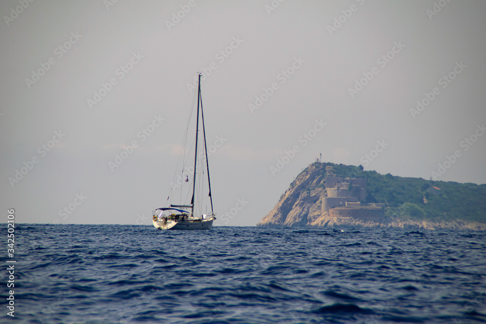 Yachts cruising on the blue sea.