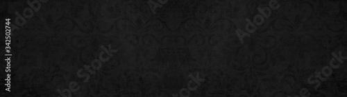 Old black anthracite vintage shabby patchwork tiles stone concrete cement wall texture background banner