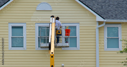 worker painting a house