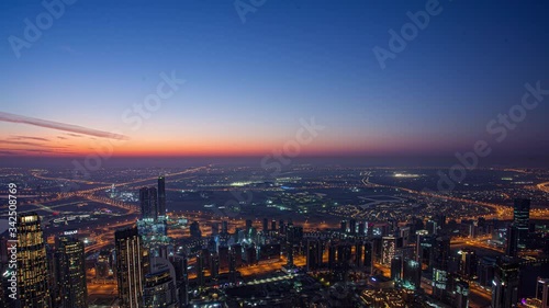 Wallpaper Mural Sunrise over Downtown in Dubai timelapse. Cloudy orange sky and hazy weather. Aerial view with towers and skyscrapers from Burj Khalifa viewpoint. Torontodigital.ca