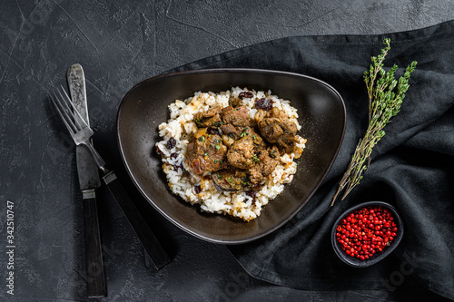 Traditional Indian curry lamb meat masala. Black background. Top view
