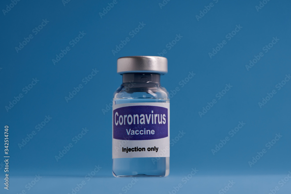 Corona virus vaccine for injection in sealed vials. Vaccine injection in sealed bottles and medical disposable plastic syringe against a blue background. Corona virus vaccine for injection in sealed vials. Vaccine injection in sealed bottles and medical disposable plastic syringe against a blue background.