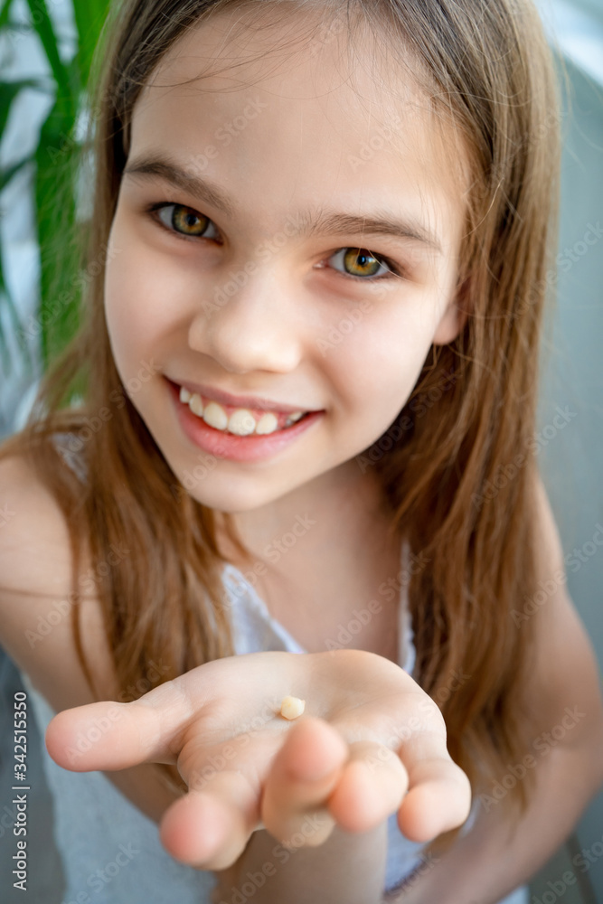 Cute teen girl showing her milk tooth fell out Cute teen girl showing her milk tooth fell out