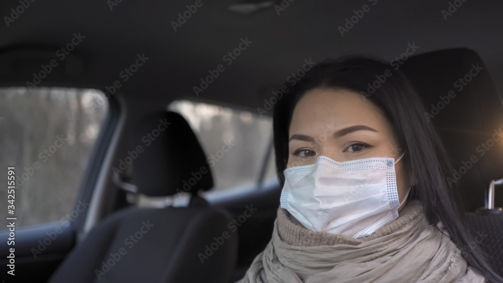 Doctor In Mask Looks At Camera Sitting In Car