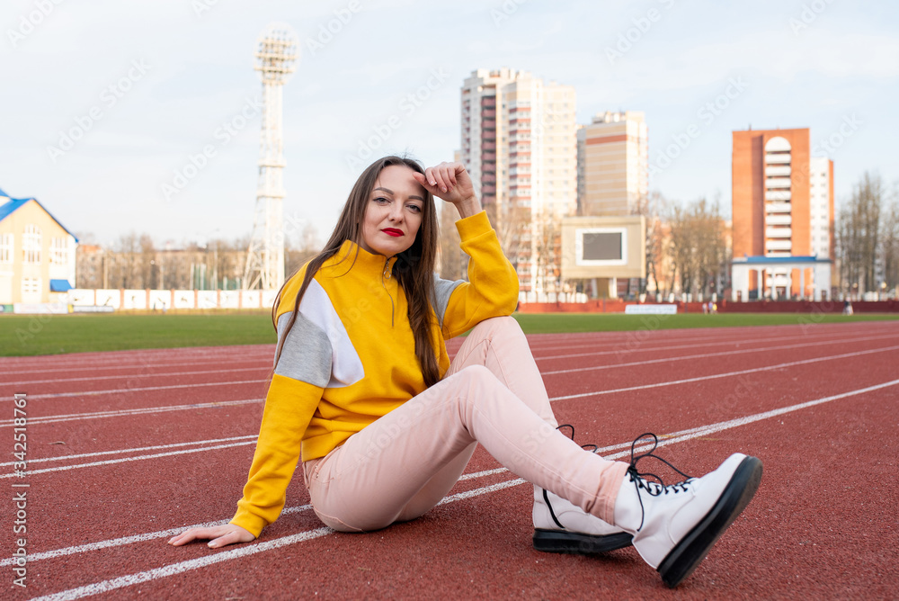 Girl, in ordinary clothes, on a treadmill of a stadium. Girl, in ordinary clothes, on a treadmill of a stadium.