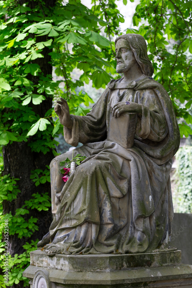 Historic Statue on the spring mystery old Prague Cemetery, Czech Republic