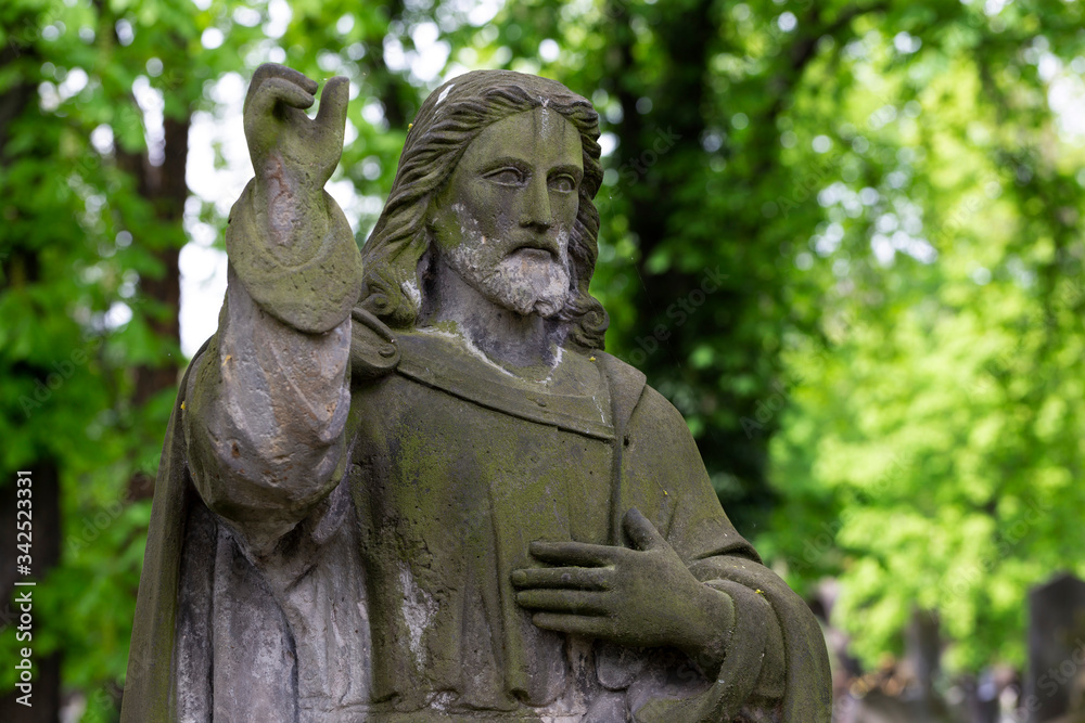 Historic Statue on the spring mystery old Prague Cemetery, Czech Republic