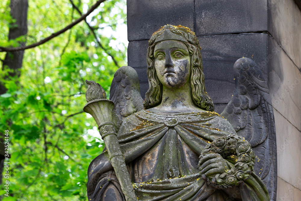 Historic Statue on the spring mystery old Prague Cemetery, Czech Republic