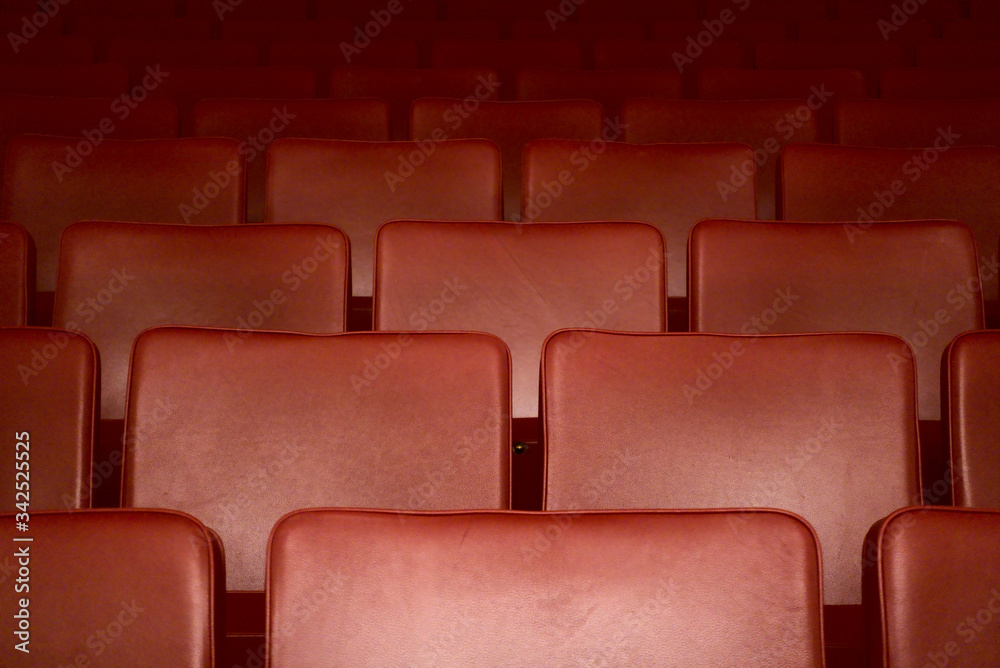 Empty red seats of a theater after the curfew regarding corona virus Empty red seats of a theater after the curfew regarding corona virus