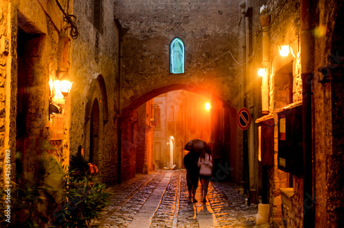 Night falls with fog wind and rain on a street in the ancient village of Erice. Sicily. Italy