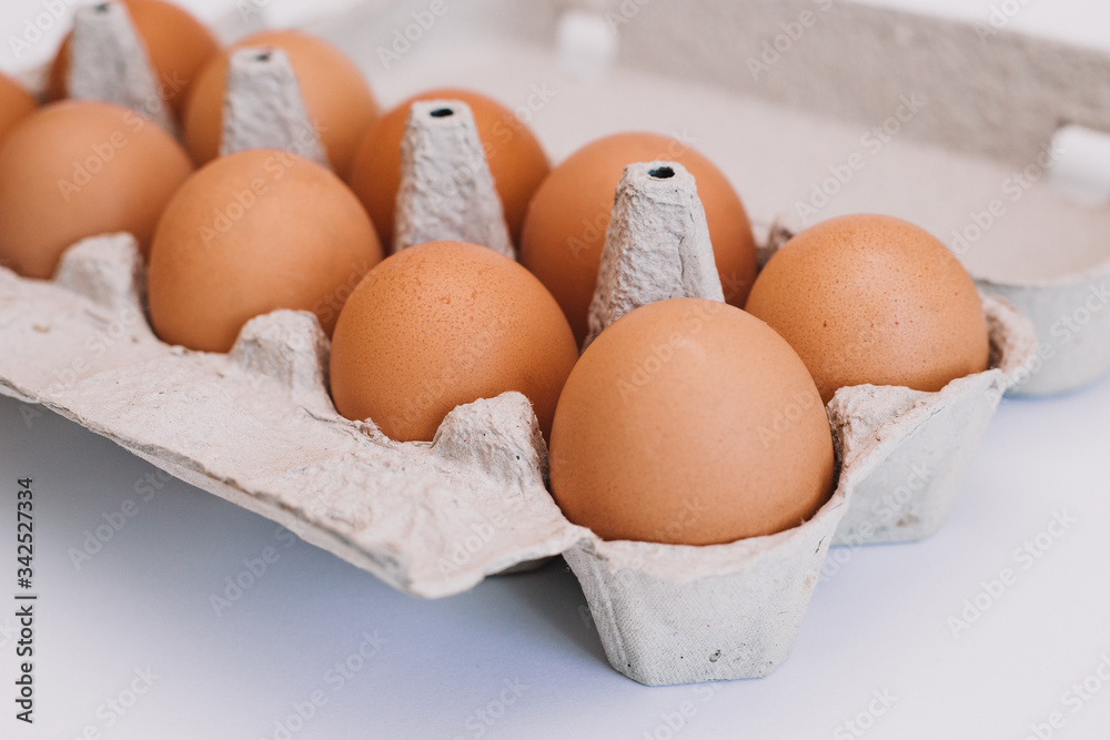 Ten eggs in carton box. Isolated on a white background. Ten eggs in carton box. Isolated on a white background.