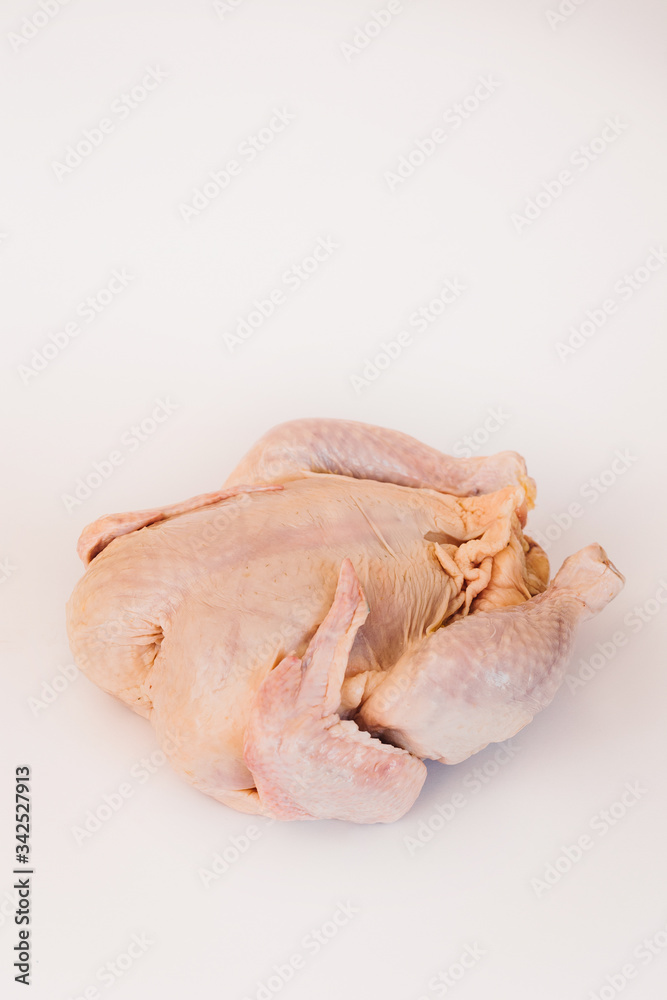 Uncooked chicken. Big and thick. Rests on the back. Isolated on a white background. Uncooked chicken. Big and thick. Rests on the back. Isolated on a white background.