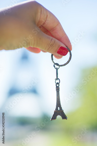Small Eifel tower in the hand with red nail