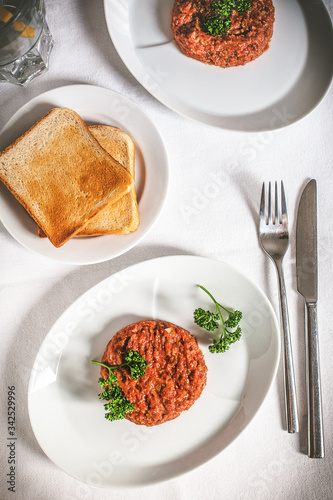 Steak tartare made of raw beef meet diced and spiced.