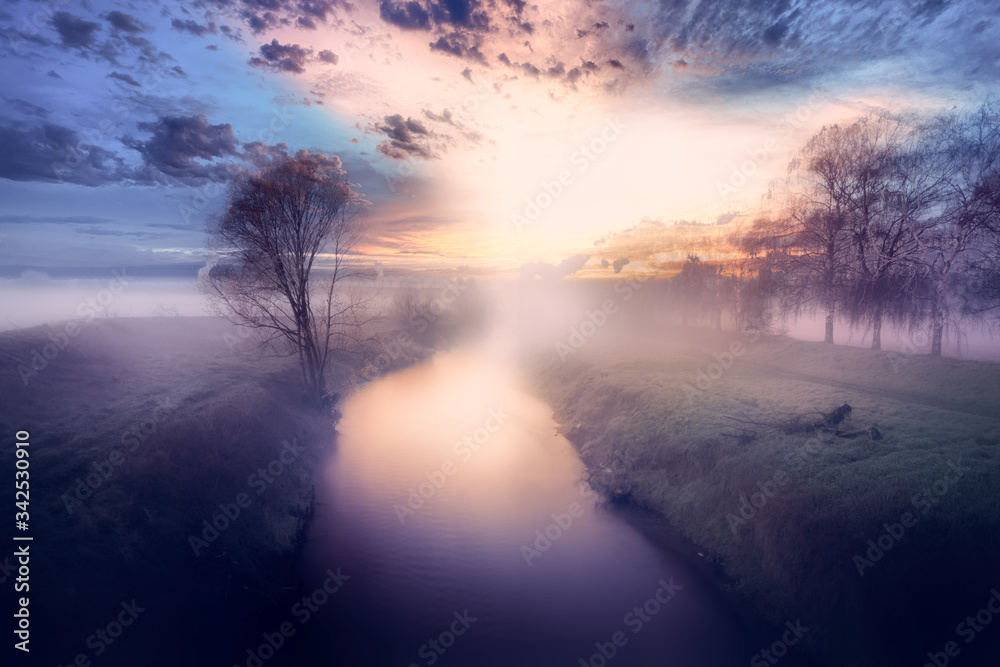 Foggy sunrise on a river in a purple color