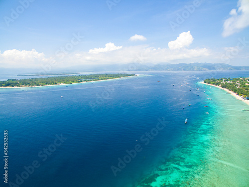 Fototapeta Naklejka Na Ścianę i Meble -  Lombok Indonesia June, 4 2020 : Tropical Island. View of nice tropical empty sandy beach, turquoise water with boats in gili trawangan lombok