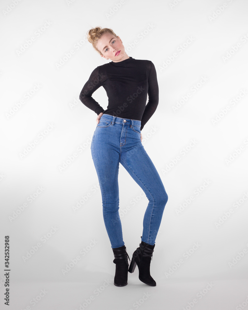 Pretty teen girl in skinny jeans and sweater. Stock Photo | Adobe Stock