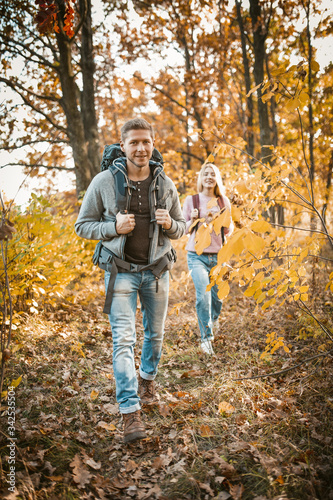 Family Hiking On Autumn Forest Footpath