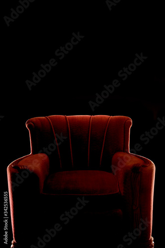 silhouette of red arm chair on black background