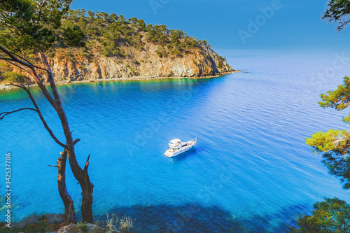 Fototapeta Naklejka Na Ścianę i Meble -  Seascape of Mediterranean sea in Turkey, lonely white yacht in picturesque pristine bay. 
