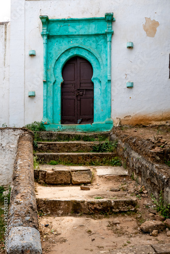 Beautiful old arabic architecture on turquoise door in Morocco © tavi004