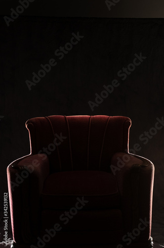 silhouette of red arm chair on black background