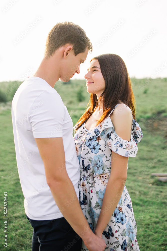 Portrait of happy couple outdoor in nature location at sunset. Portrait of happy couple outdoor in nature location at sunset.