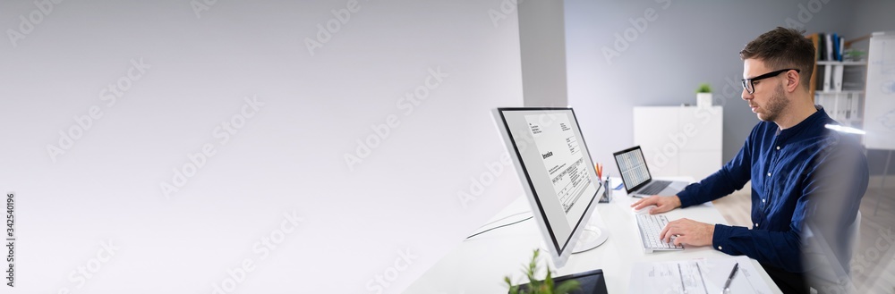 Businessman Calculating Invoice In Office
