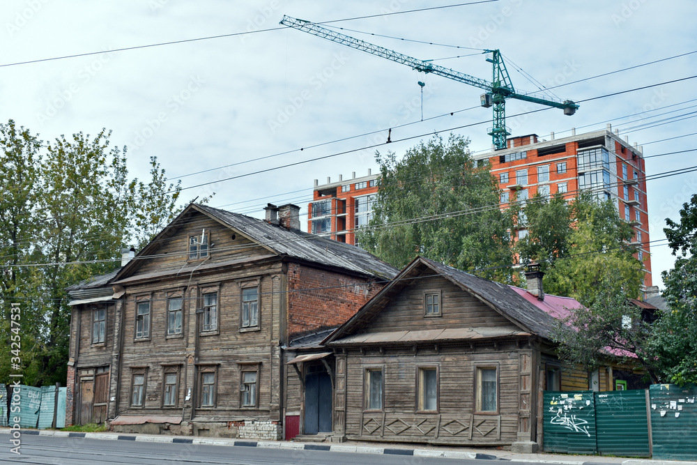 construction on the background of wooden houses. Nizhny Novgorod. Russia construction on the background of wooden houses. Nizhny Novgorod. Russia