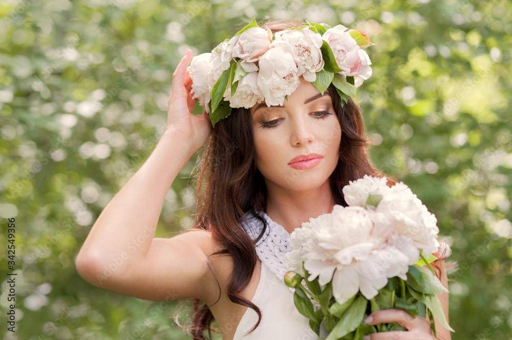 young women with spring wreath and bouquet of white peonies in hands young women with spring wreath and bouquet of white peonies in hands