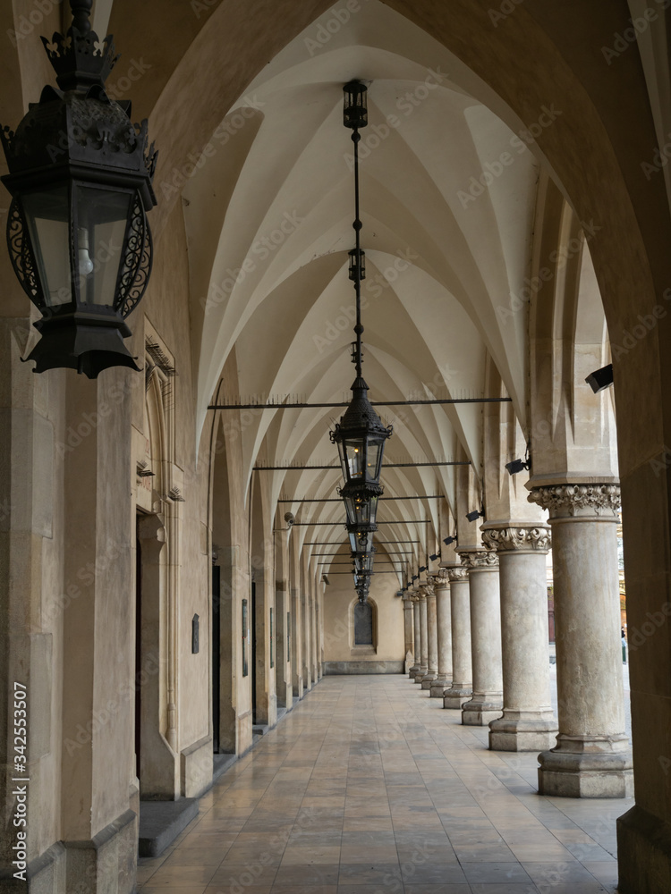Empty arcades of Sukiennice on empty Krakow's Main Market Square during covid-19 coronavirus pandemic.