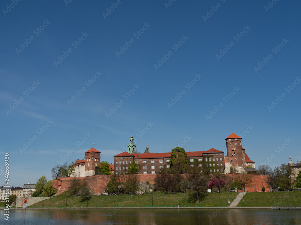 The former Royal residence of Polish monarchy, Wawel Castle, Krakow, Poland. Spring time, view from the Vistula river boulevard.  Negative space fora copy.