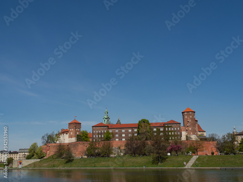 The former Royal residence of Polish monarchy, Wawel Castle, Krakow, Poland. Spring time, view from the Vistula river boulevard. Negative space fora copy.