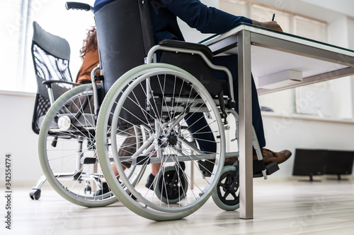 Disabled Businessman Sitting On Wheelchair