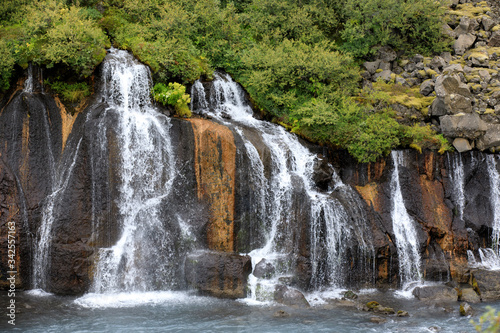 Hraunfossar   Iceland - August 15  2017  Hraunfossar waterfalls formed by rivulets streaming out of the Hallmundarhraun lava field formed by the eruption of a volcano  Iceland  Europe