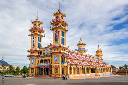 Cao Dai temple area and meditating followers of the Cao Dai religion in the t...