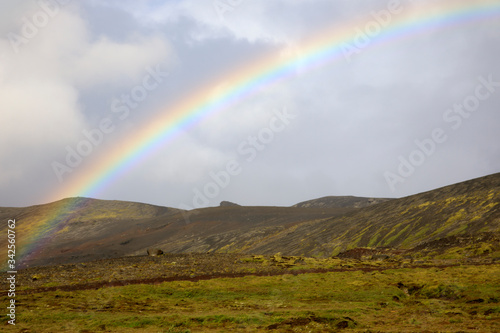 Iceland - August 15, 2017: The spectacullar rainbow arc on a hill near the Ring Road, Iceland, Europe