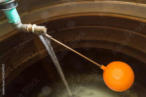 New float ball valve in stainless steel water tank.