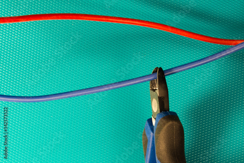 Cutting red or blue wire by wire cutters. Safety precautions, bomb neutralization photo